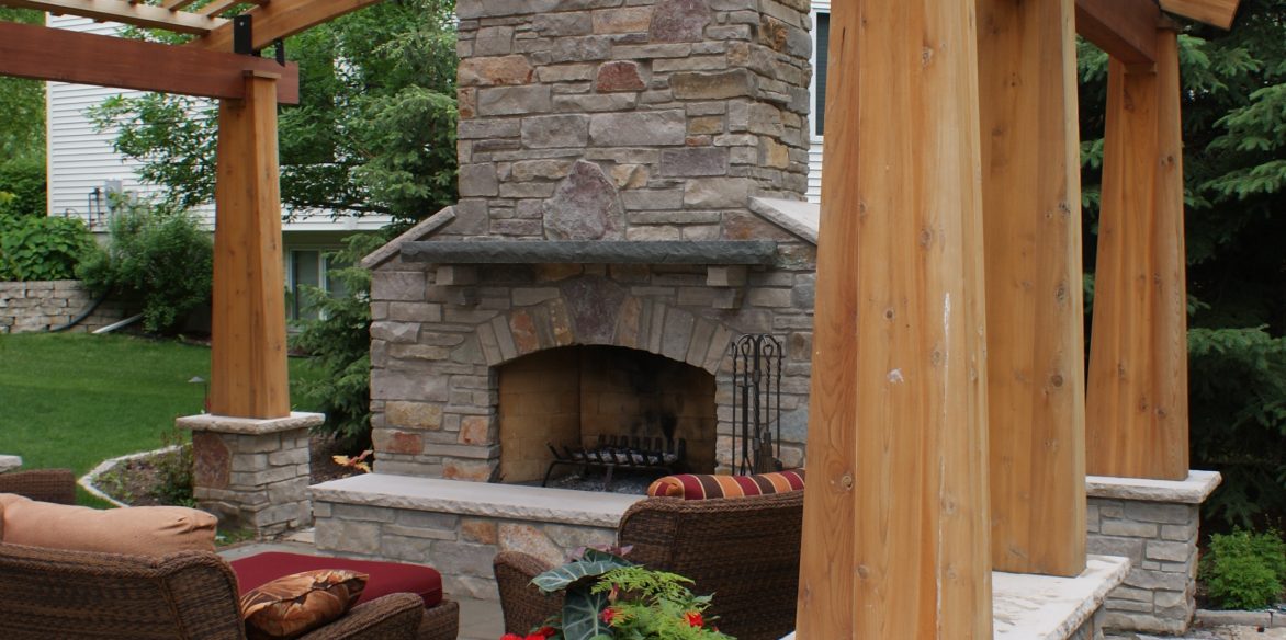 Arching cedar pergola and fireplace